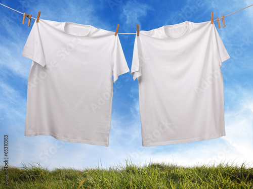 Blank white t-shirt hanging on clothesline