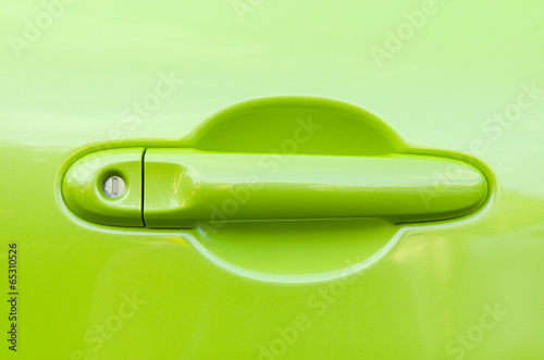 green handle on the door of the car