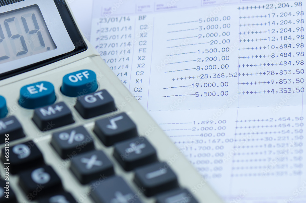 close up bank statement with calculator close up bank statement with calculator