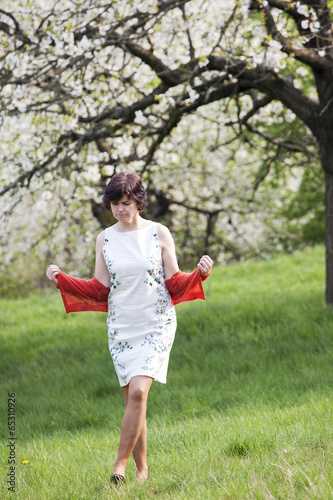 Woman is recovering under blooming cherry tree old photo