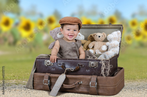 Kleines Kind vor einem Sonnenblumenfeld