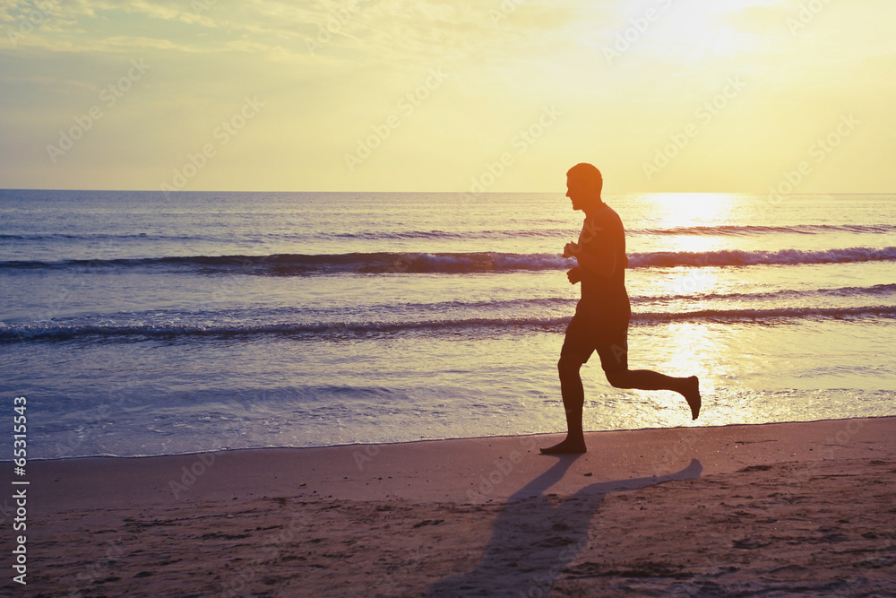 healthy lifestyle, silhouette of runner on the beach
