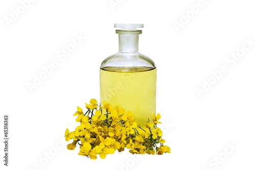 glass bottle of rape seed oil with rape flowers