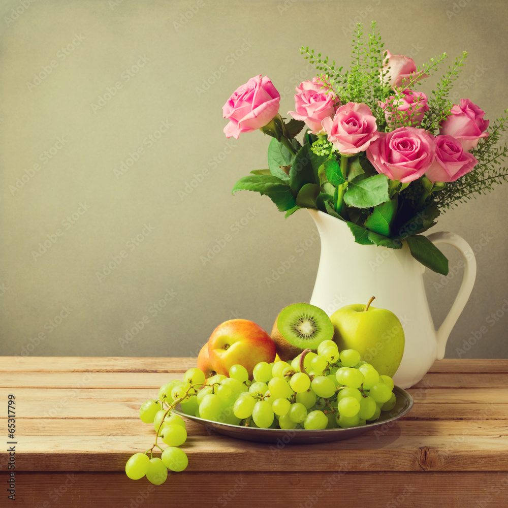 Rose flowers and fruits on wooden table - obrazy, fototapety, plakaty 