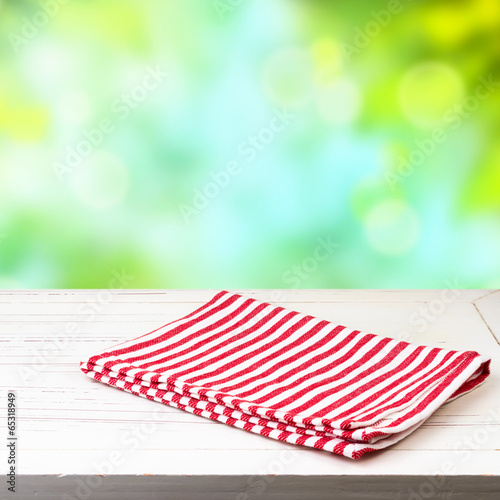 Empty wooden table and red striped tablecloth