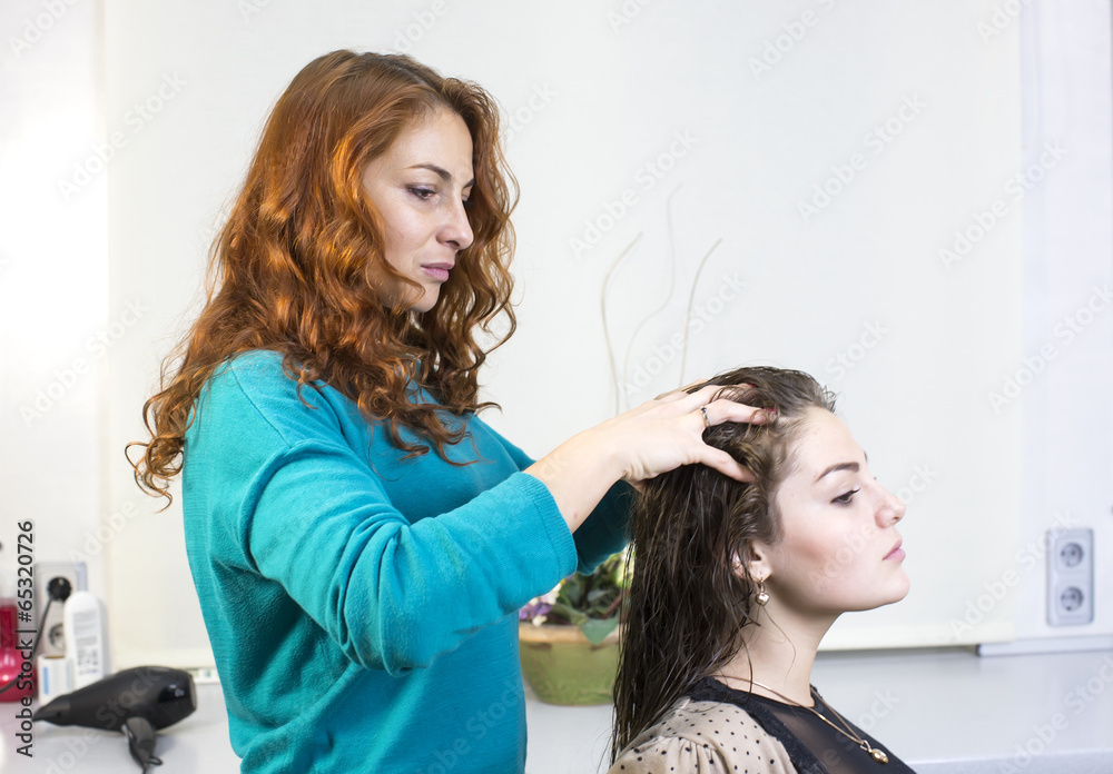 Fototapeta premium woman in a beauty salon doing hair