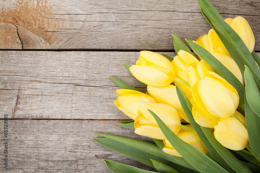 Fresh yellow tulips over wooden table - obrazy, fototapety, plakaty 