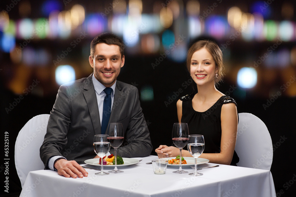 smiling couple eating main course at restaurant smiling couple eating main course at restaurant