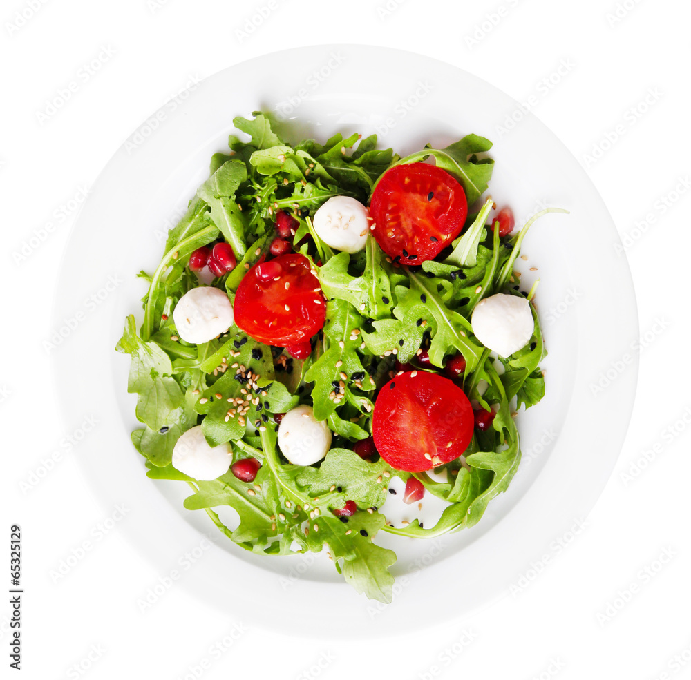Green salad made with arugula, tomatoes, cheese mozzarella Green salad made with arugula, tomatoes, cheese mozzarella