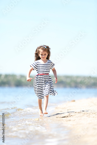 Beautiful little girl on the beach © Africa Studio