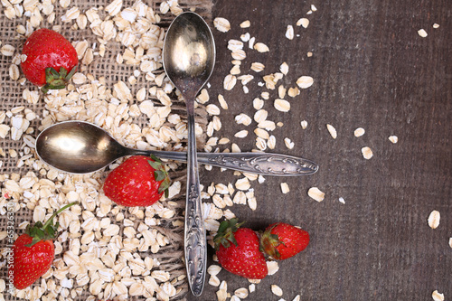Strawberries with oatmeal and vintage spoons,