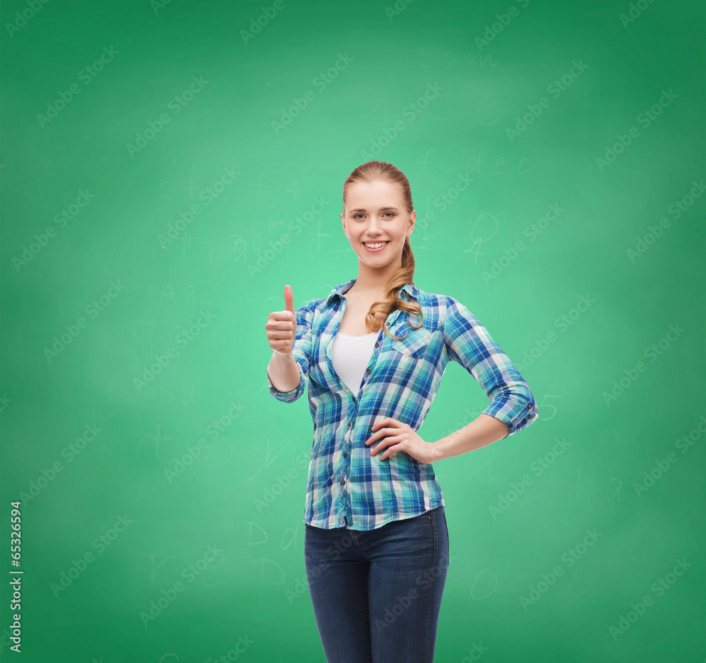 young woman in casual clothes showing thumbs up