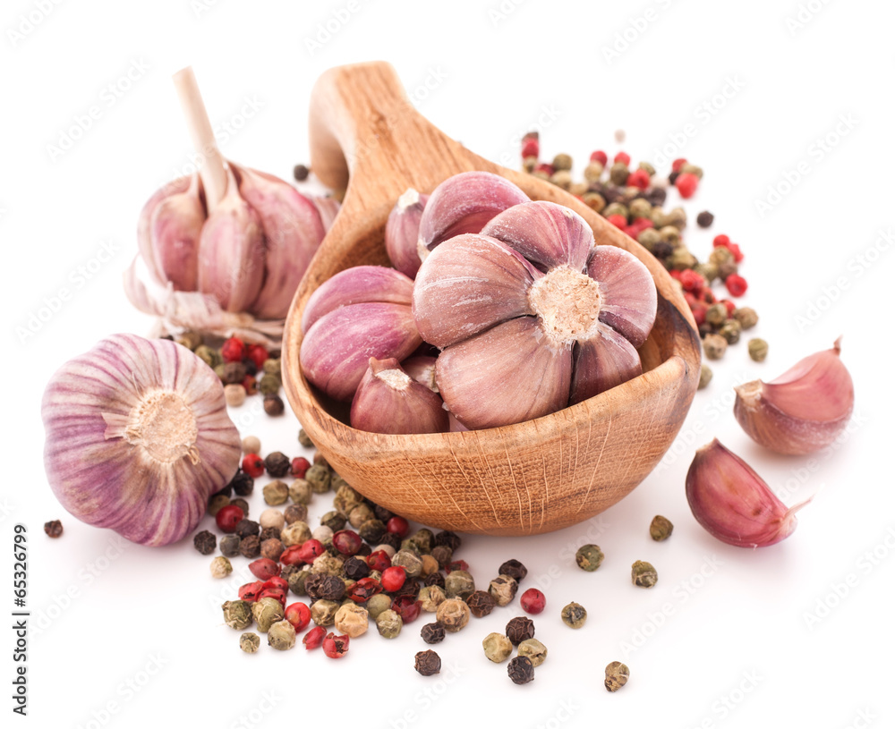 Garlic cloves in wooden bowl isolated on white background Garlic cloves in wooden bowl isolated on white background