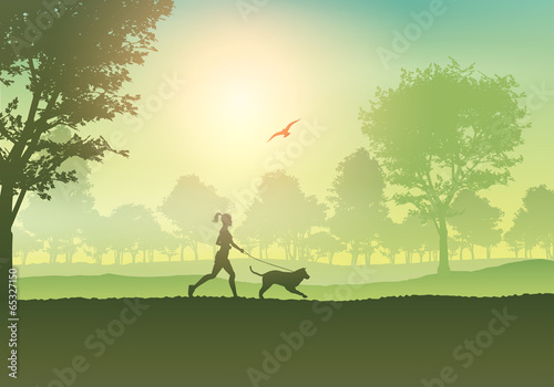 Female jogging with dog in countryside