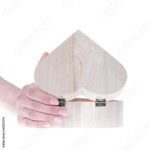 Hand hold heart shaped wooden gift box isolated on white