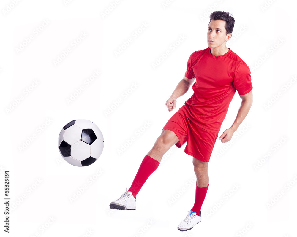 Soccer player kicking the ball, isolated on white background