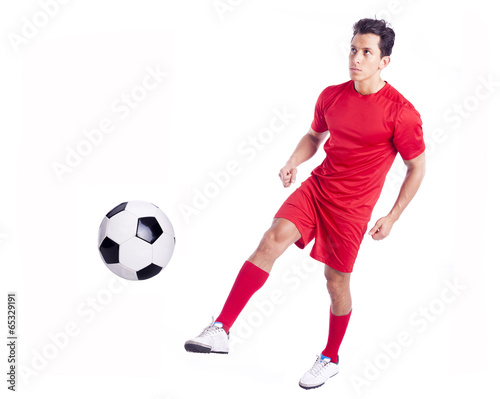 Fototapeta Naklejka Na Ścianę i Meble -  Soccer player kicking the ball, isolated on white background
