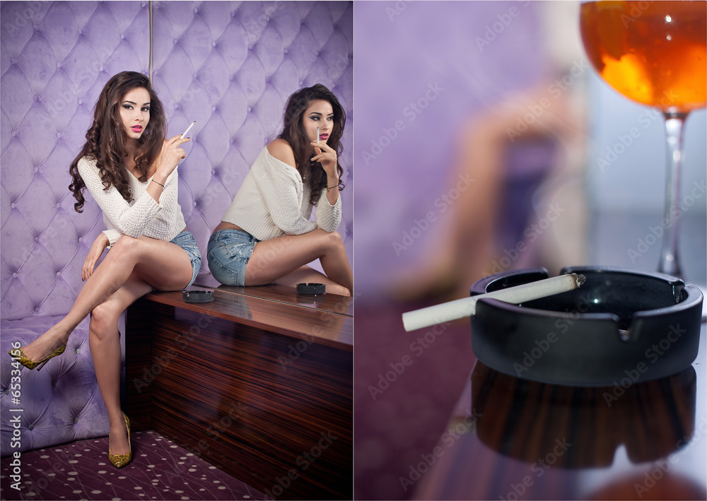 Young sensual woman siting smoking in a modern night club