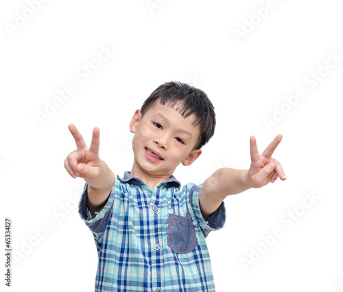 portrait of little boy showing victory hands sign