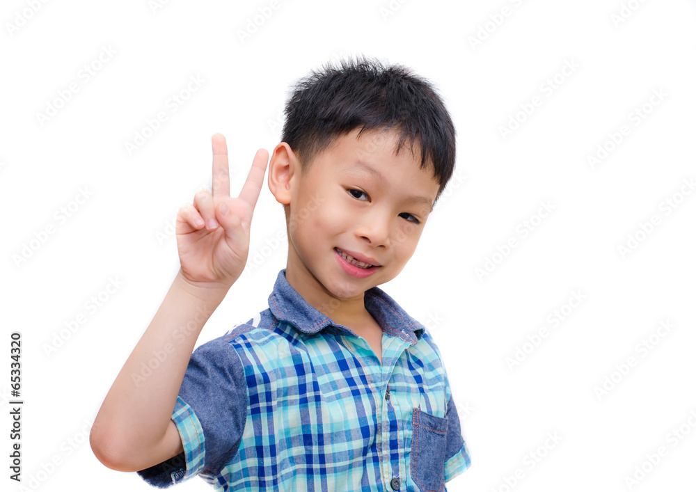 portrait of little boy showing victory hand sign portrait of little boy showing victory hand sign
