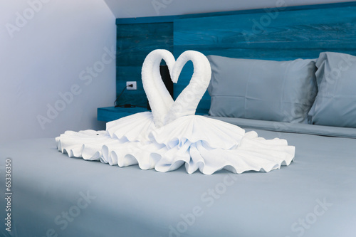Fototapeta Naklejka Na Ścianę i Meble -  Bedroom interior design with swans from the towel decoration on