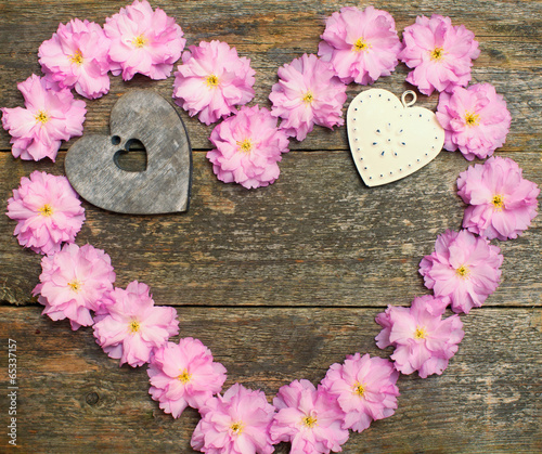 pink flowers and heart on the wooden background