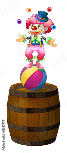 A clown juggling above the barrel
