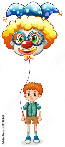 A boy holding a clown balloon with an eyeglass