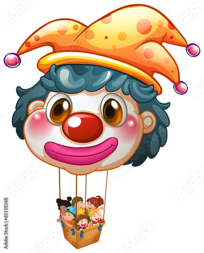 A big clown balloon with kids in the big basket