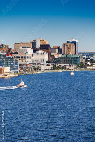 Tugboat Sailing Past Halifax Vertical