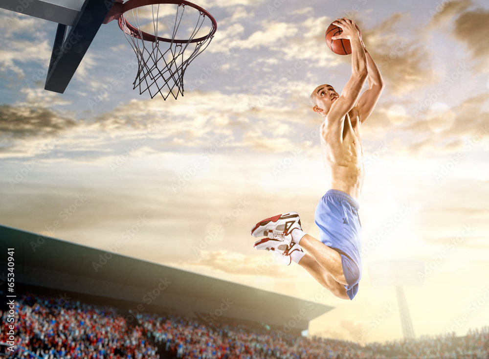 Basketball player in action on background of sky and crowd