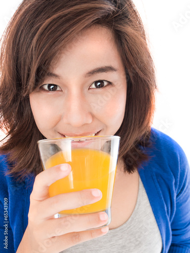 Isolated portrait of young happy woman drinking orange juice smi