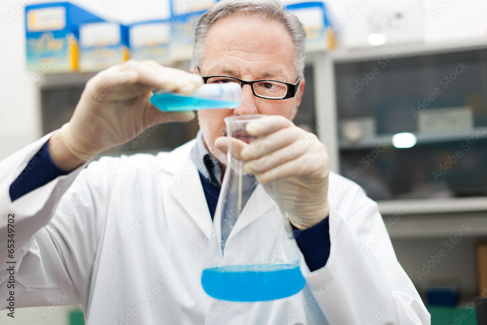 Scientist filling an Erlenmeyer flask Scientist filling an Erlenmeyer flask