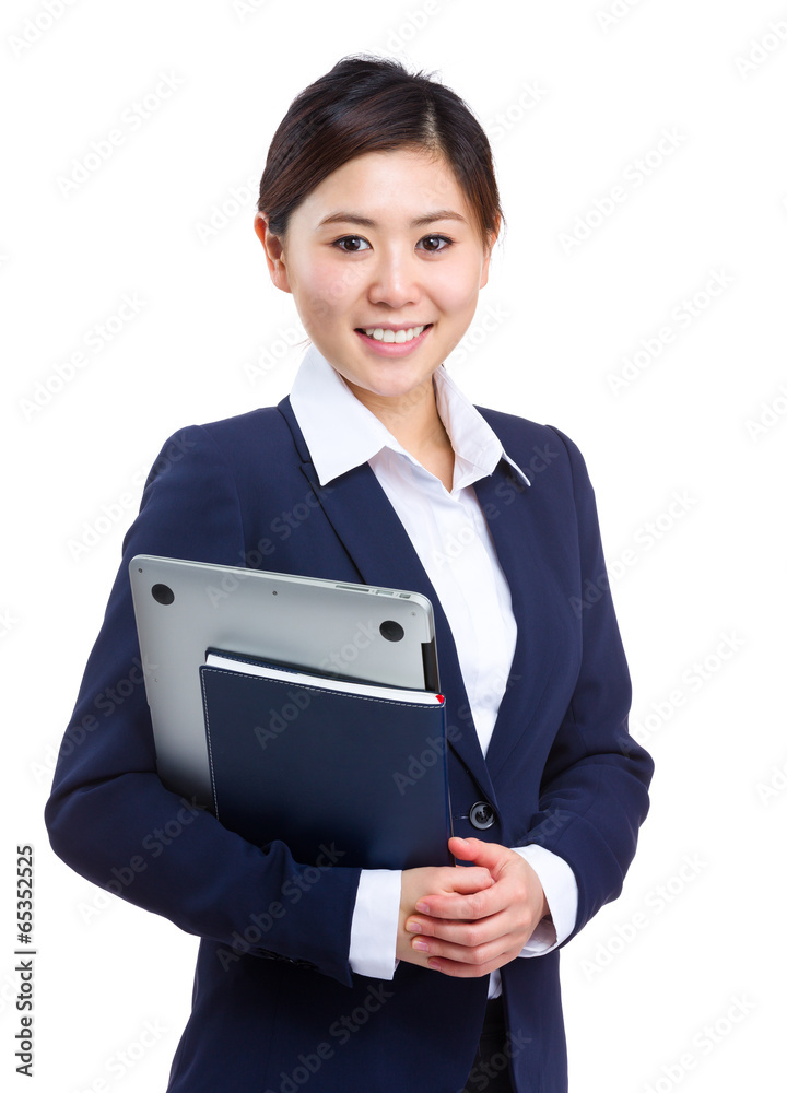 Businesswoman holding laptop and notebook Businesswoman holding laptop and notebook