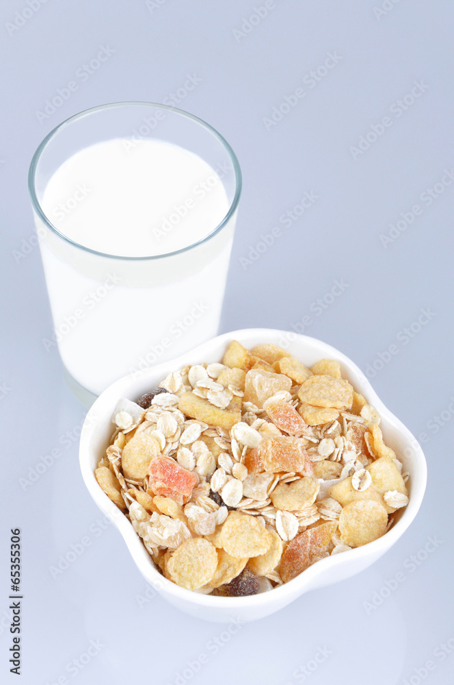 Cereals with dried and candied tropical fruit and glass of milk Cereals with dried and candied tropical fruit and glass of milk