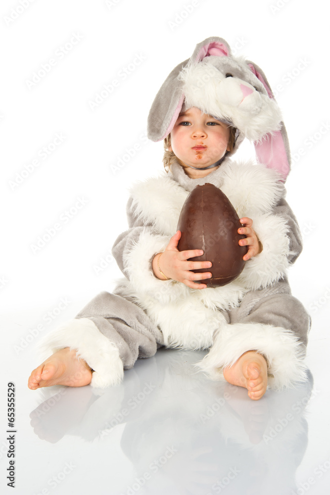 Fototapeta premium Little bunny eating easter egg