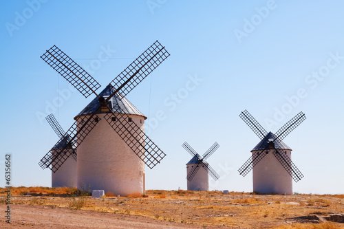 Group of retro windmills in field