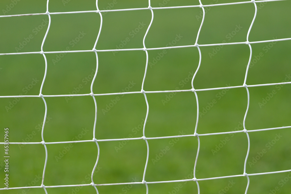 Soccer behind goal net Soccer behind goal net