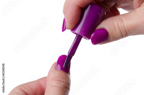Woman s hand applying nail varnish