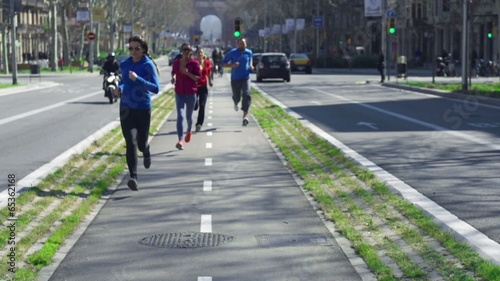 People jogging on the street, slow motion shot at 120fps, steady