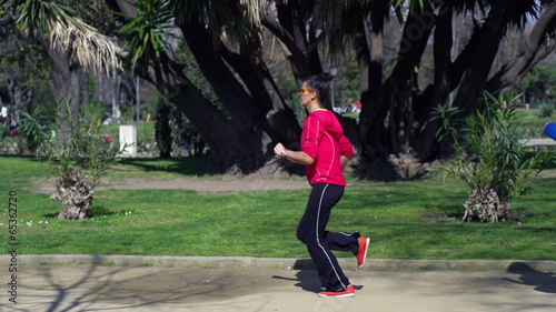 Joggers passing each other in park, slow motion shot at 240fps, 