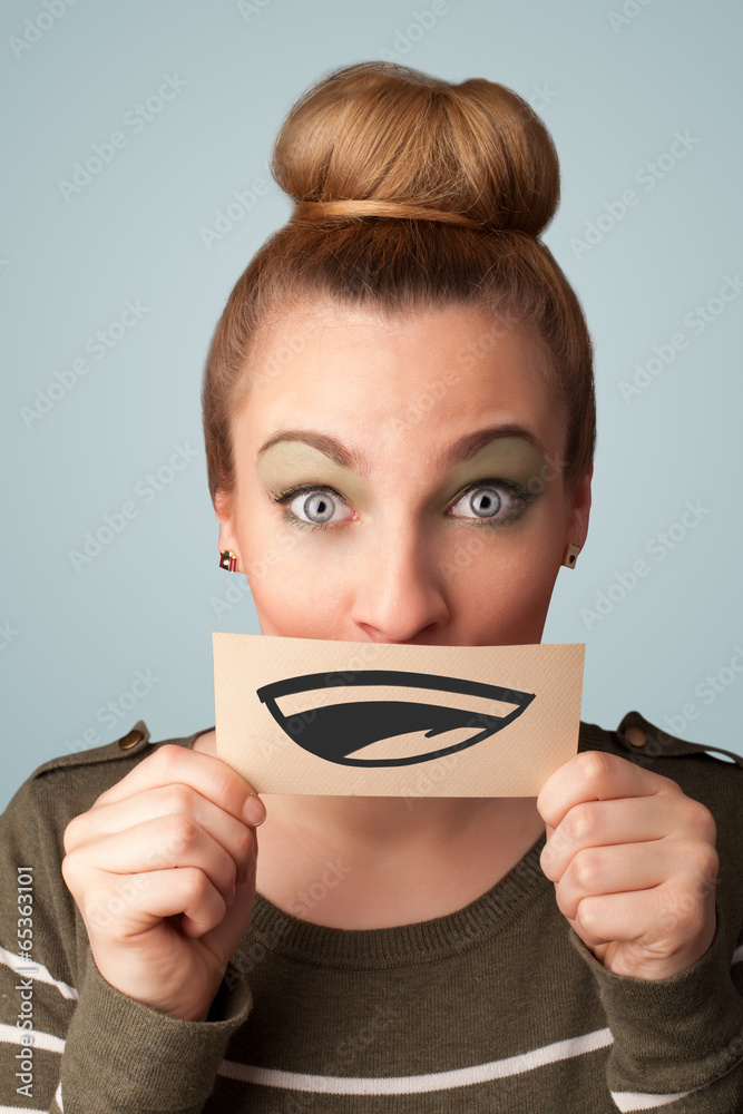 Pretty young girl holding white card with smile drawing Pretty young girl holding white card with smile drawing