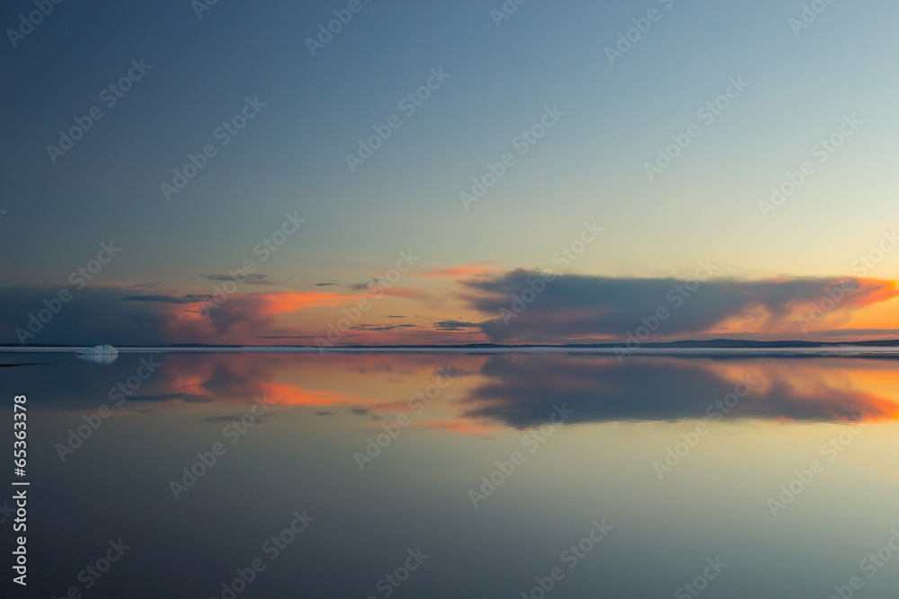 Fototapeta premium Melting spring mountain lake in the setting sun.