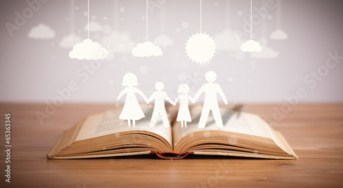 Slika na platnu Cardboard figures of the family on opened book