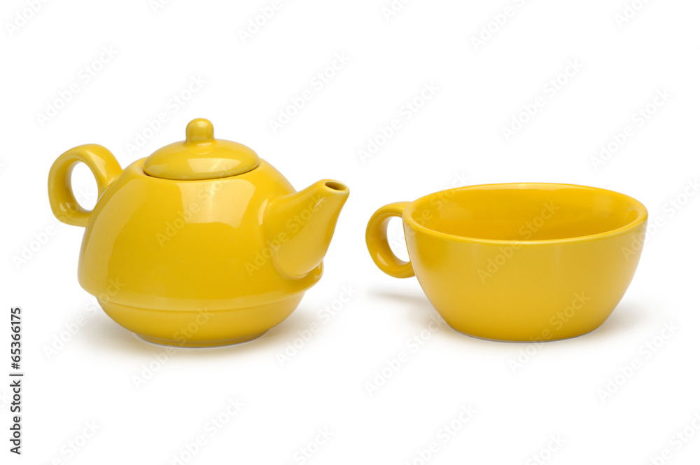Set of a yellow ceramic teapot and mug isolated on a white backg Set of a yellow ceramic teapot and mug isolated on a white backg