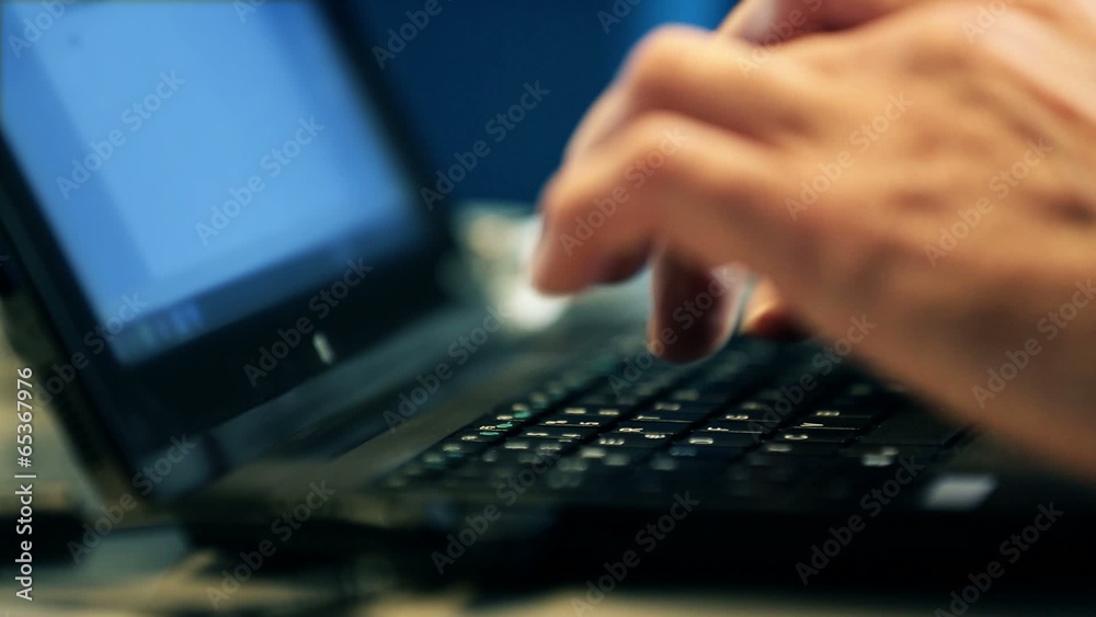 Hacker typing program on a laptop keyboard Hacker typing program on a laptop keyboard