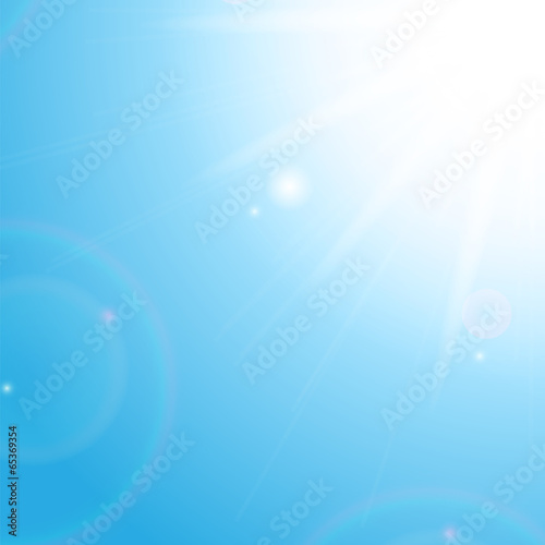 Sun and sunbeams on the background of blue sky