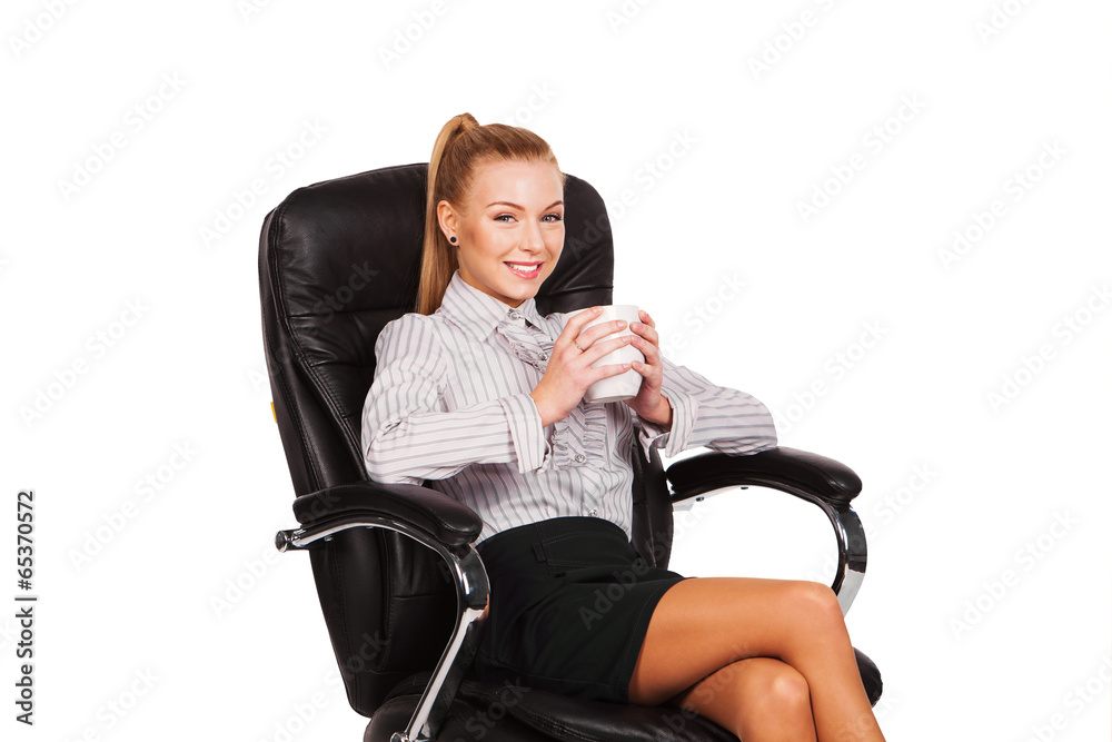 Business woman with cup sitting in the chair Business woman with cup sitting in the chair