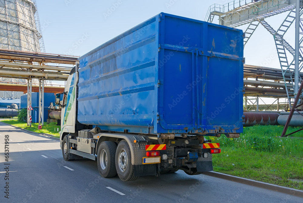 Naklejka premium Blue truck drives near the thermal plant.