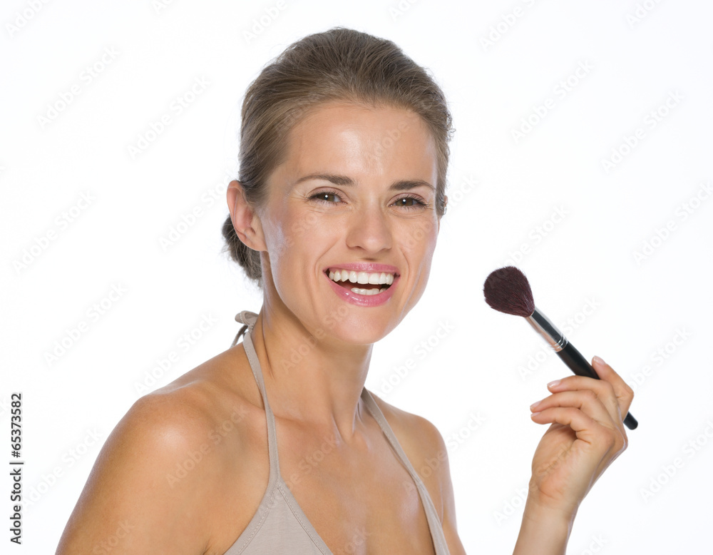 Portrait of happy young woman with makeup brush Portrait of happy young woman with makeup brush